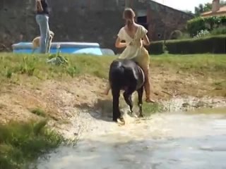 girl in dress riding a horse in pool